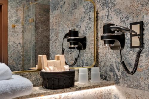 a bathroom with two lights on a wall at Park Hotel Diament Katowice in Katowice