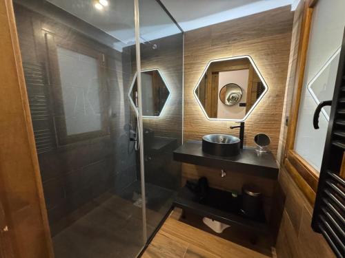 a bathroom with a shower with a sink and a mirror at Immodelpas Pic Blanc in Pas de la Casa