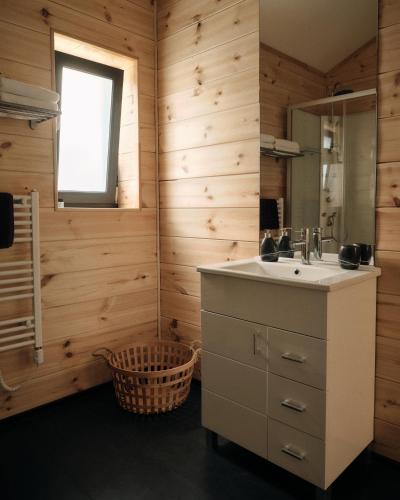 a bathroom with a sink and a mirror at Bakony Deep Forest Vendégház in Bakonyszentlászló
