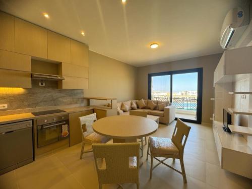 a kitchen and living room with a table and chairs at 3 bedrooms penthouse with sea view in Hurghada