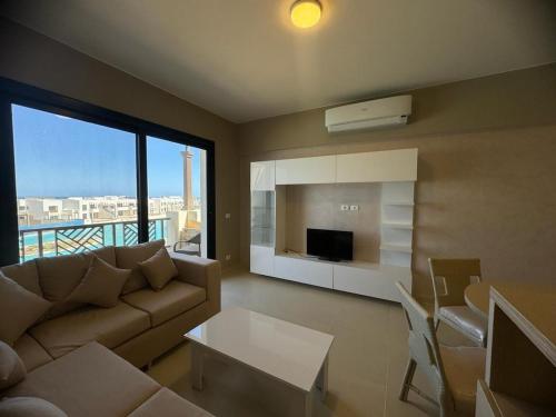 a living room with a couch and a table at 3 bedrooms penthouse with sea view in Hurghada
