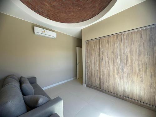 a living room with a couch and a wooden wall at 3 bedrooms penthouse with sea view in Hurghada