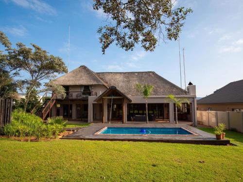 an exterior view of a house with a swimming pool at Weavers Nest Guesthouse in Modimolle