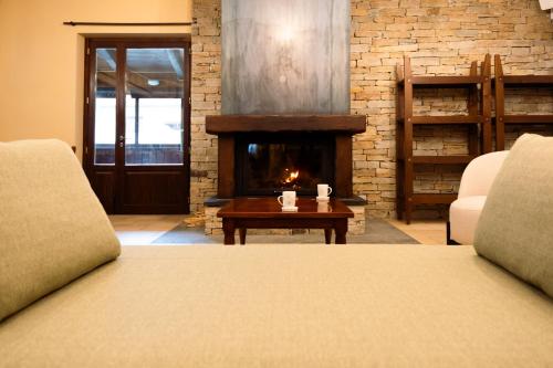 a living room with a fireplace and a bed at Hotel Chalet Seggiovia in Pontechianale