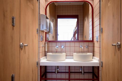 a bathroom with two sinks and a mirror at The Central House Valencia Mercado Central in Valencia