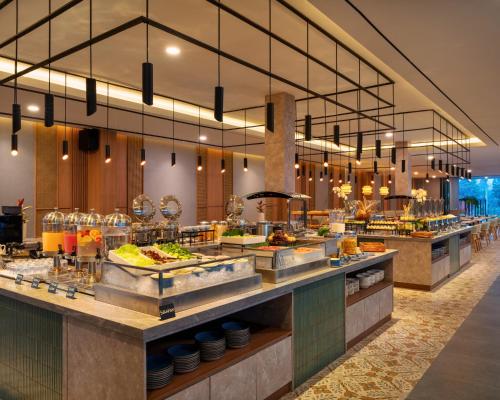 a buffet line in a restaurant with food at Laska Hotel & Resort Ciater in Ciater