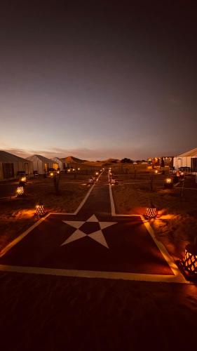 a road with a star on it at night at Dream Luxury Majestic Camp in Merzouga