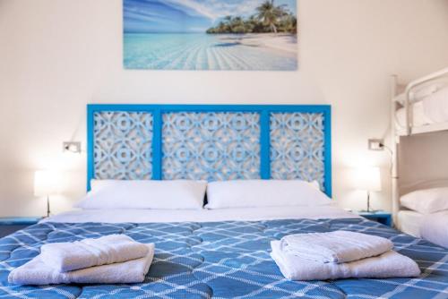 a bedroom with a blue bed with two pillows on it at Bilocale sul mare, Agrigento7 - Riccione in Riccione
