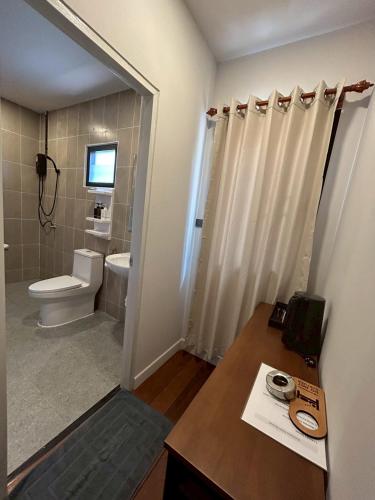 a small bathroom with a toilet and a sink at Coco Valley Koh Tao in Ko Tao