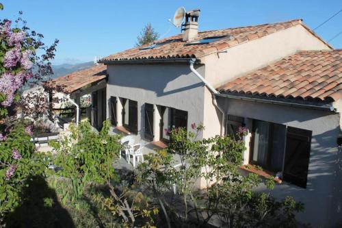 a white house with a red tile roof at La bastide du rousset in Ascros