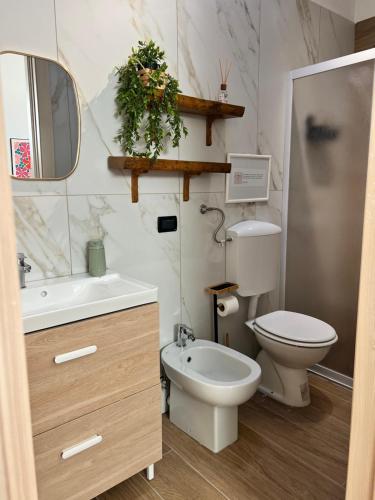 a bathroom with a toilet and a sink and a mirror at LOFT EMILIA a Castel Bolognese self check-in in Castel Bolognese