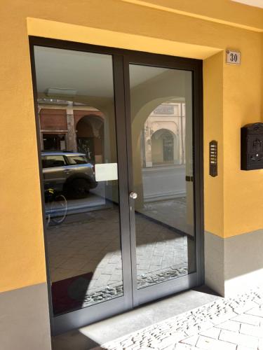a sliding glass door with a reflection of a street at Loft Emilia a Castel Bolognese in Castel Bolognese