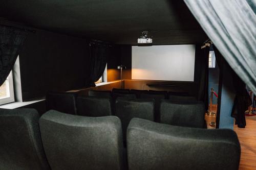 a cinema room with green chairs and a screen at Zur alten Oelmuehle Wellness & Entertainment in Ahrhütte