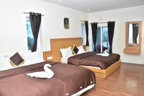 Ένα ή περισσότερα κρεβάτια σε δωμάτιο στο Magizham Homestay