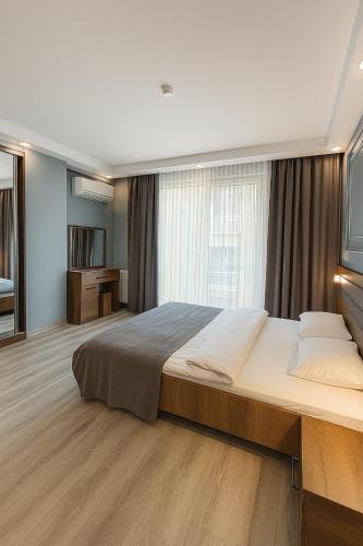 a bedroom with a large bed and a large window at On4 Rooms & Suites in Istanbul
