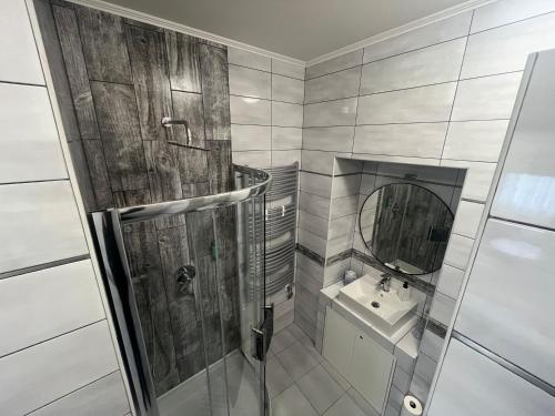 a bathroom with a shower and a sink at Apartmány PARK in Klášterec nad Ohří