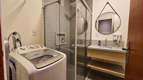 La salle de bains est pourvue d'un lave-linge et d'une douche. dans l'établissement Refúgio Aconchegante na Cidade, à Campinas