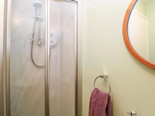 a shower in a bathroom with a mirror at Little Thornsett in Buxton