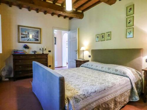 a bedroom with a large bed and a dresser at Apartment With Terrace And Pool Near Lucca in San Quirico di Moriano