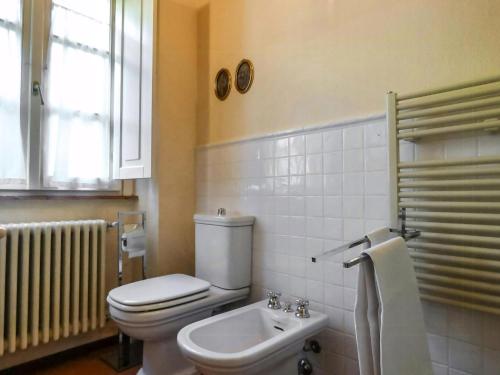 a bathroom with a toilet and a sink at Apartment With Terrace And Pool Near Lucca in San Quirico di Moriano