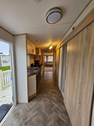 a hallway of a house with a kitchen at KMH Caravans at Flamingo Land in Kirby Misperton