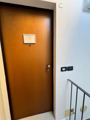 a brown door with a sign on it at Loft Emilia a Castel Bolognese in Castel Bolognese