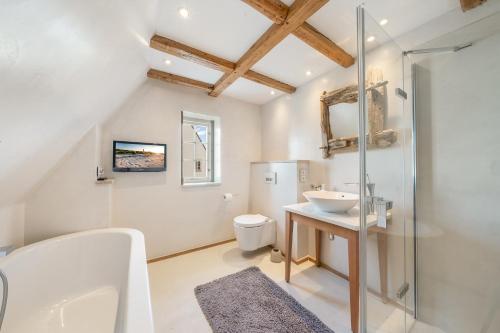 a white bathroom with a sink and a toilet at Lighthouse 2 in Hörnum