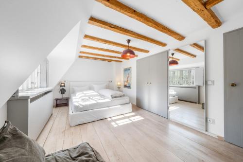 a bedroom with a bed in a room with white walls at Lighthouse 2 in Hörnum