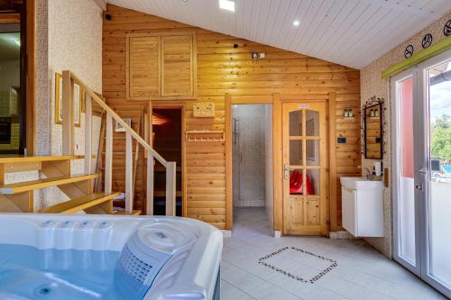 a bathroom with a tub and a sink at Family friendly house with a swimming pool Ogulin, Gorski kotar - 15204 in Gornje Dubrave