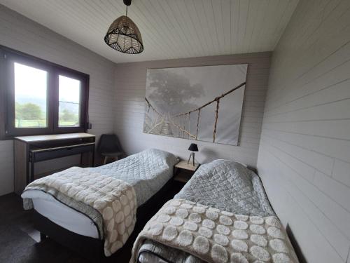 Ένα ή περισσότερα κρεβάτια σε δωμάτιο στο Durbuy - Chalet 4 personen