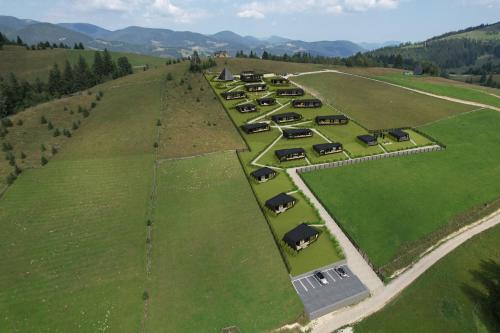 an aerial view of a field with cars in it at Emshir Villas in Krasnik