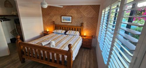 a bedroom with a wooden bed with a window at Beach side studio Quindalup in Quindalup