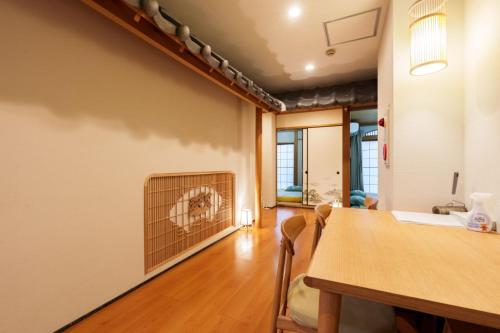 a dining room with a table and a fireplace at Just a short walk 心斎橋 Glico Sign 1min 道頓堀30-second 黒門市場 難波駅 Dotonbori Guesthouse 松の阁 in Osaka