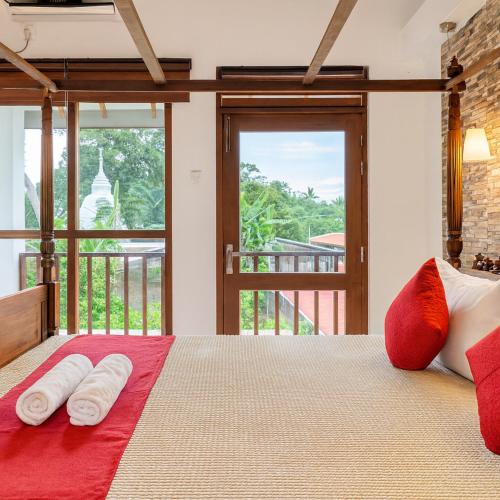 a bedroom with a bed with two towels on it at Bentota Luxe Ayurveda in Bentota
