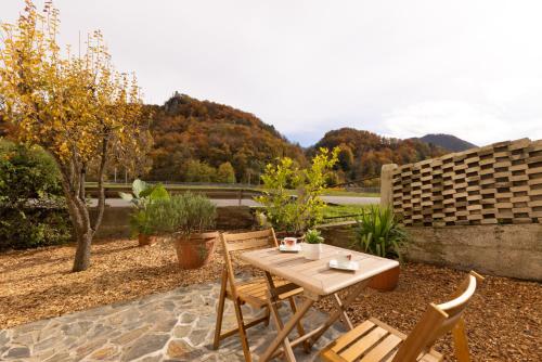 a wooden table and chairs sitting on a patio at Apartment Arc 23 in Celje
