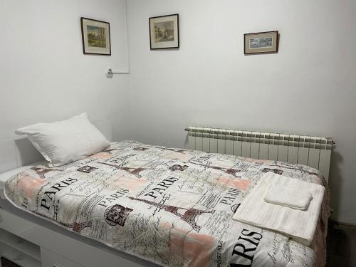 a bed with a comforter on it in a bedroom at Райска тишина in Zlatitsa