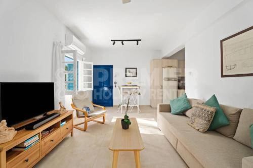 a living room with a couch and a tv at Apartment Themis in Protaras