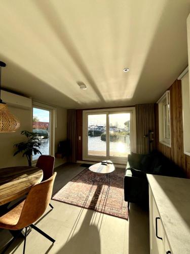 a living room with a couch and a table at Houseboat Sneek in Sneek