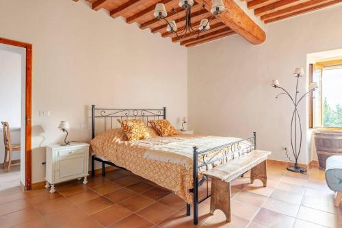 a bedroom with a bed and a bench in a room at Il Tinaio di Mary in Cetona