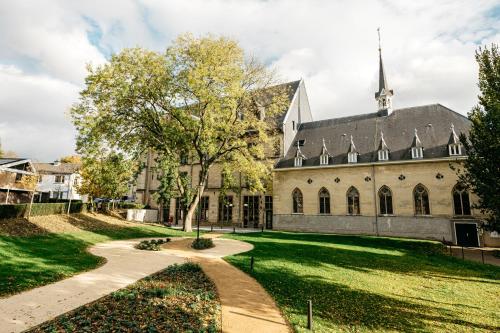 a large stone building with a pathway leading to it at Boutique Hotel Kint in Valkenburg