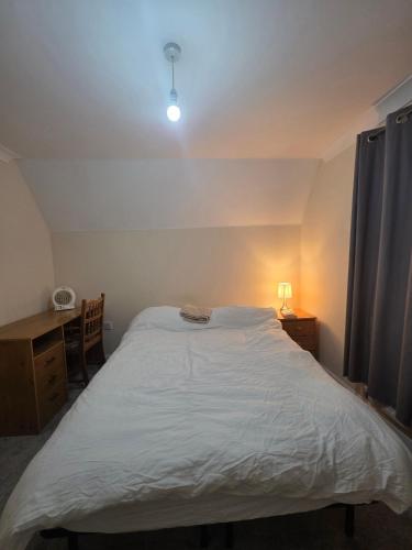 a bedroom with a large white bed and a desk at Cozy Guest Room in Colchester - Perfect for Travelers in Hythe