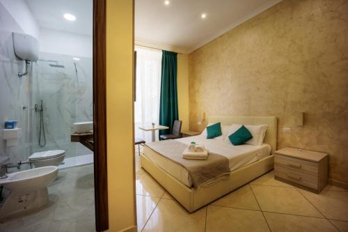 a bedroom with a bed and a bathroom with a shower at Re Diego in Naples