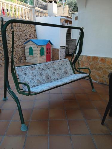 a bench with a bird house on it at Casa Alice in La Nucía