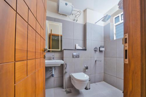 a bathroom with a toilet and a sink at MYSA Sky Suites, Lakkidi in Vythiri