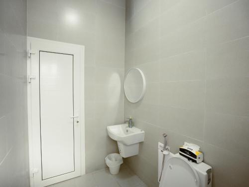 a bathroom with a toilet and a sink and a mirror at Al-Salam Villa-Family Pool & Private Garden in Misfāh
