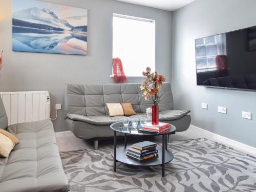 a living room with a couch and a table at Apartment 2 - Uk50136 in Stoke on Trent