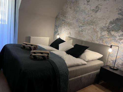 a bedroom with a large bed with white pillows at Apartament Ski &Sun in Świeradów-Zdrój