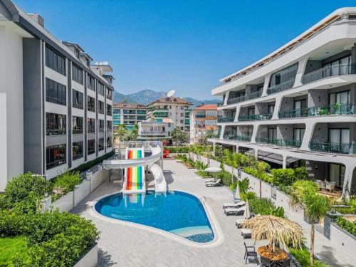 an apartment complex with a pool and a rainbow at Coastal Retreat with Pool and Balcony in Alanya