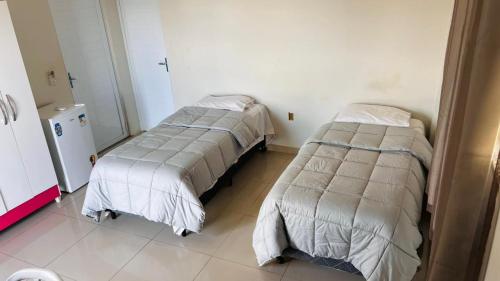 a room with two beds in a room at Hotel Panorama Palace in Janaúba