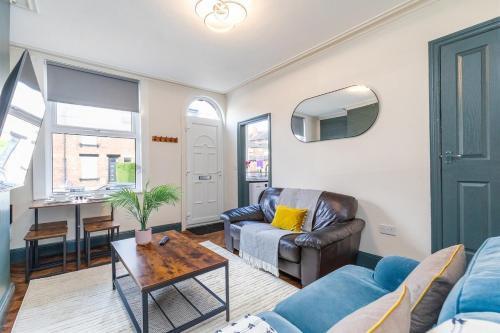 a living room with a couch and a table at Broomfield Terrace in Headingley